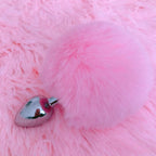 A pink bunny tail butt plug with a detachable stainless steel plug